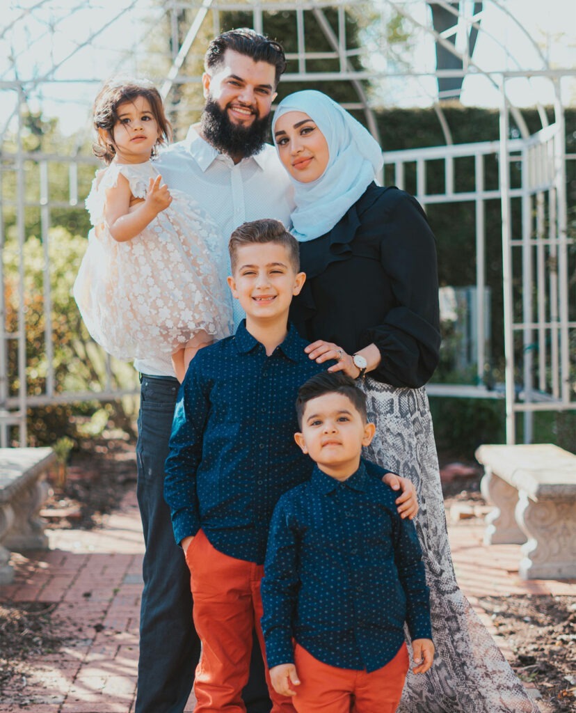 smiling arabic family posing together for photo