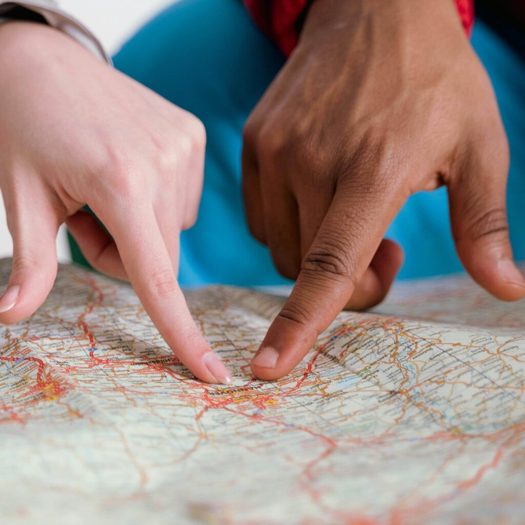 hands pointing on a map