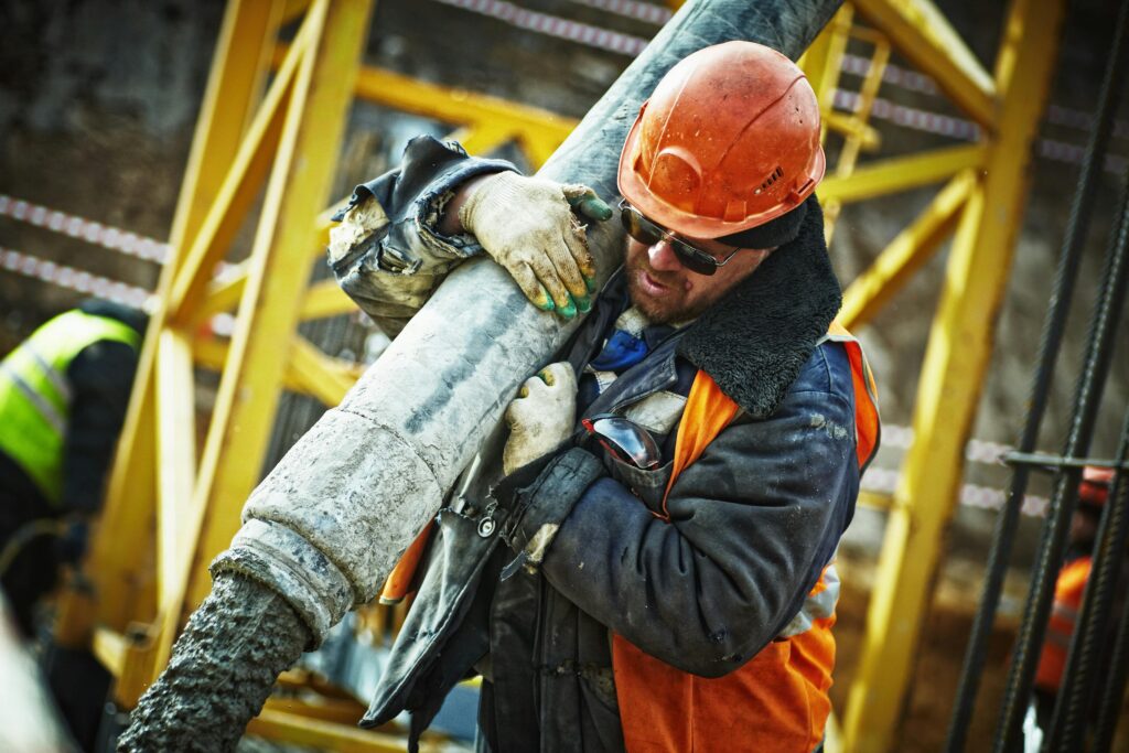 man holding cement pouring pipe
